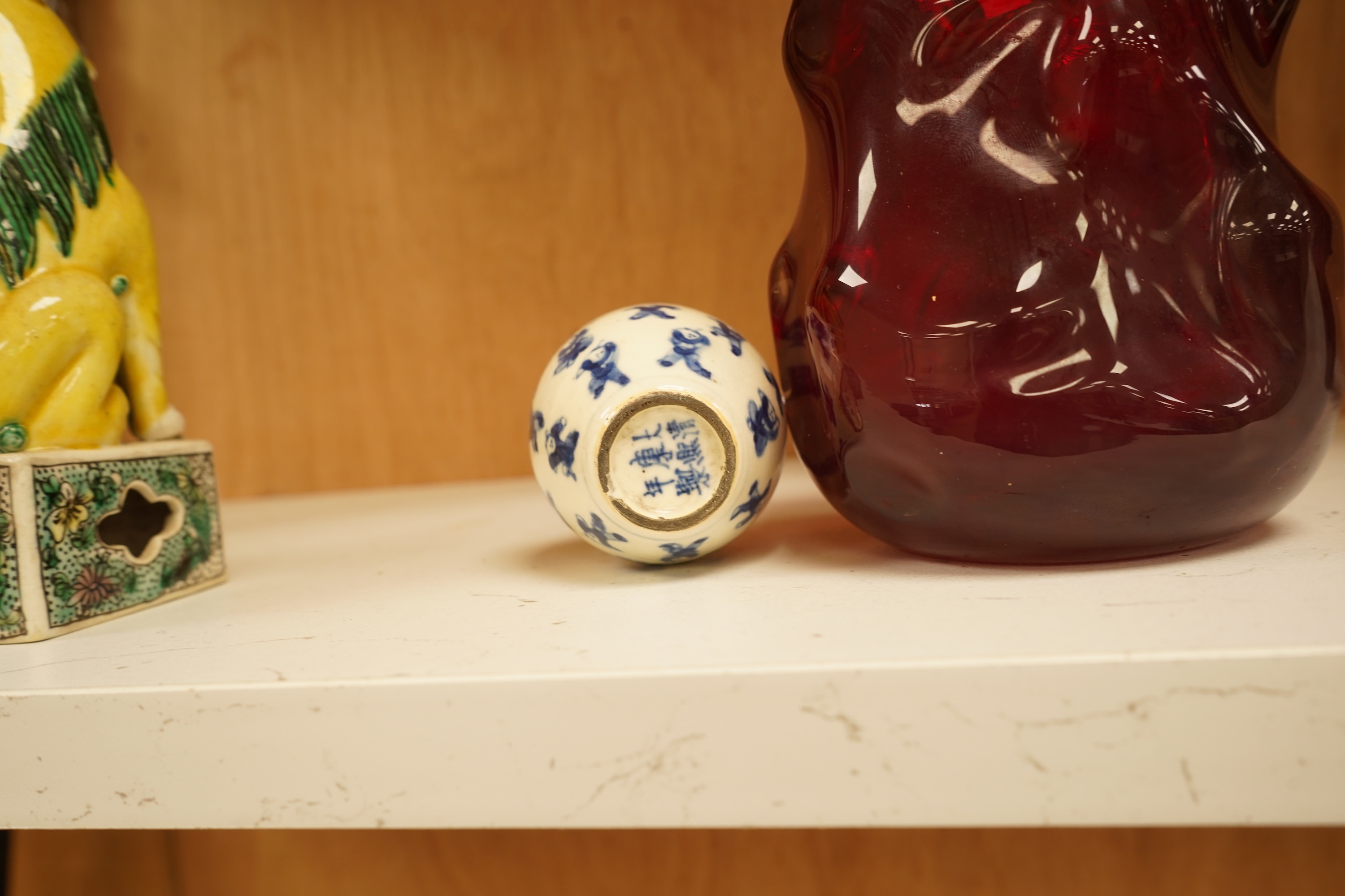 A pair of late 19th/early 20th century Chinese famille verte lion dogs and a similar pair of blue and white miniature ‘boys’ jars and covers, 15cm